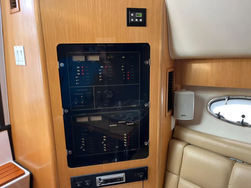 Slide: The Image of Control panel inside 2001 Tiara Yachts 4100 Open, featuring wood finish and leather seating. - 25