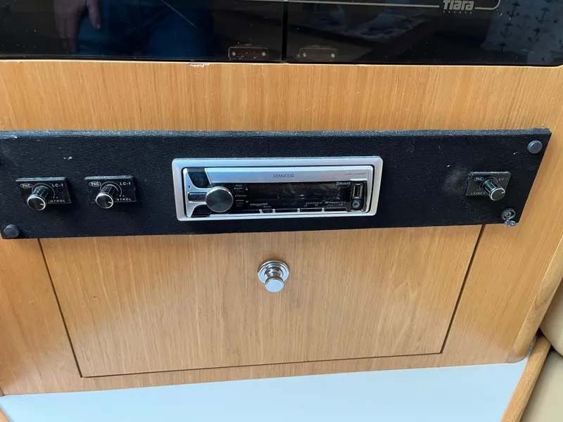 Slide: The Image of Control panel of a 2001 Tiara Yachts 4100 Open, featuring a stereo system. - 28