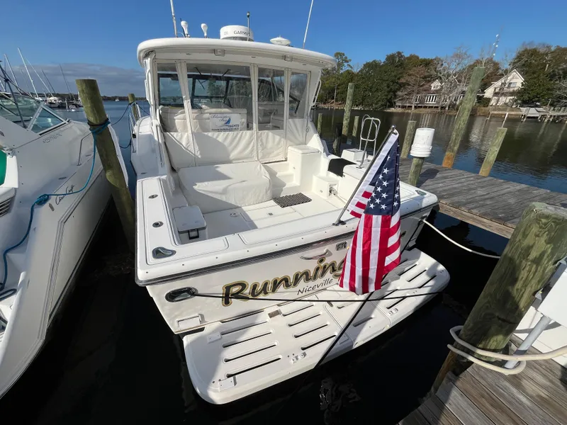 Slide: The Image of 2001 Tiara Yachts 4100 Open docked with American flag, rear view. - 3