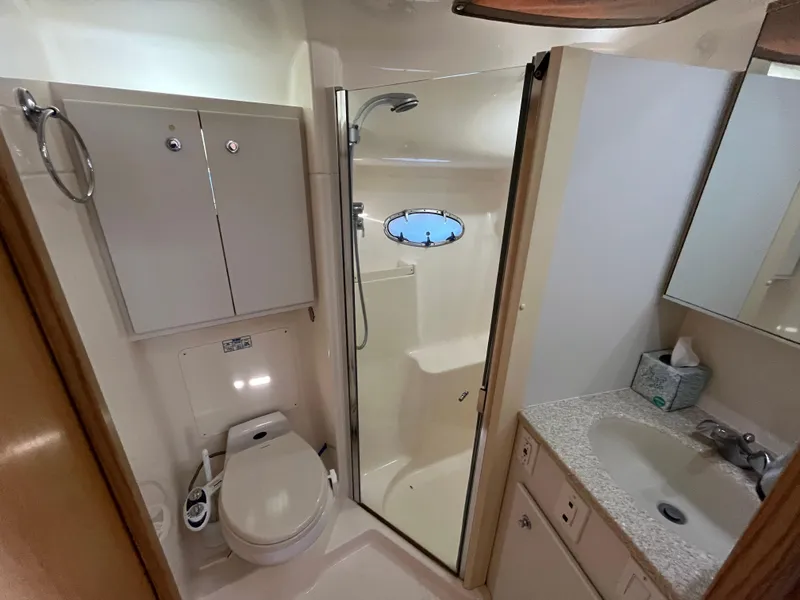 Slide: The Image of Bathroom interior of 2001 Tiara Yachts 4100 Open, featuring shower, toilet, and sink. - 36