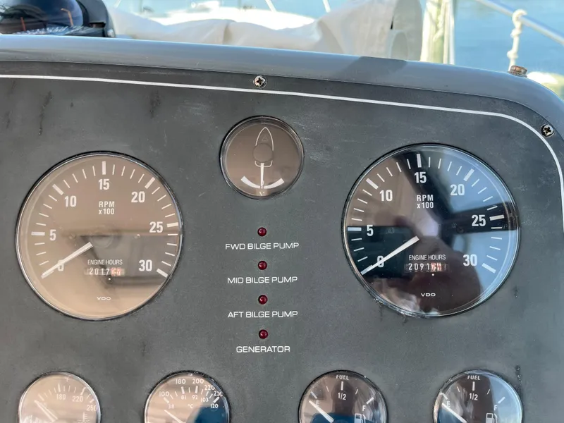 Slide: The Image of Dashboard of 2001 Tiara Yachts 4100 Open with gauges and bilge pump indicators. - 4
