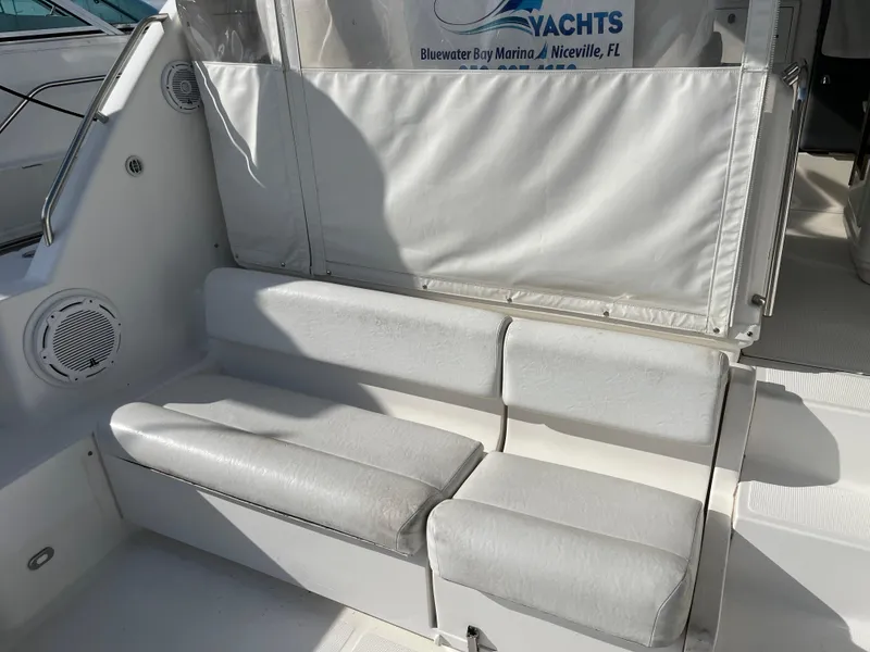 Slide: The Image of 2001 Tiara Yachts 4100 Open seating area with white cushions and speaker. - 48