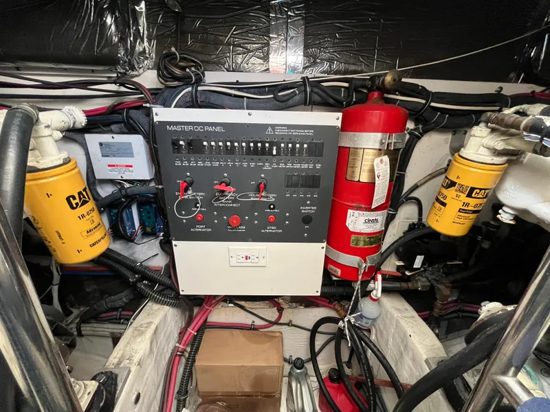 Slide: The Image of Engine room of 2001 Tiara Yachts 4100 Open with control panel and fire extinguisher. - 5