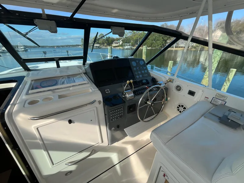 Slide: The Image of 2001 Tiara Yachts 4100 Open helm with steering wheel and navigation controls. - 7