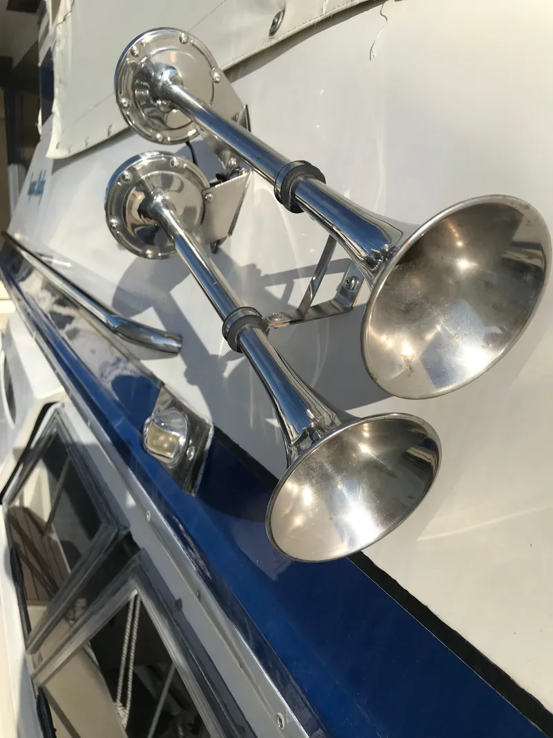 Slide: The Image of Close-up of chrome horns on a 1987 Sea Ray 410 Aft Cabin boat. - 15