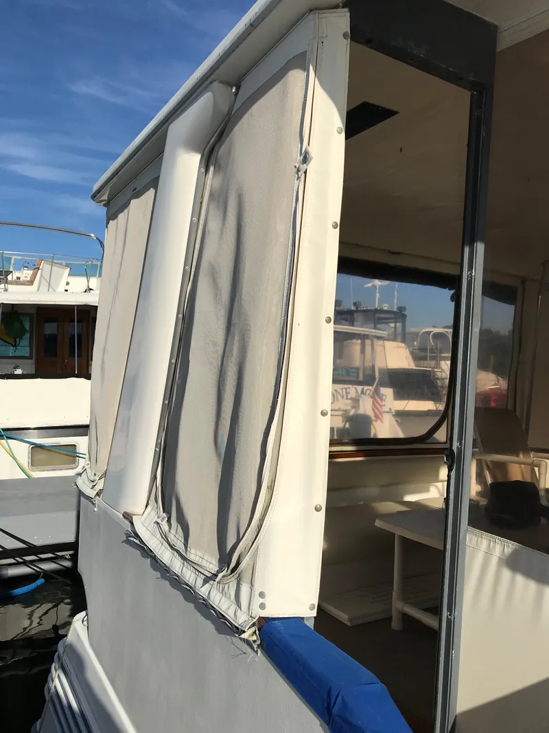 Slide: The Image of 1987 Sea Ray 410 Aft Cabin boat with covered deck and seating area. - 23