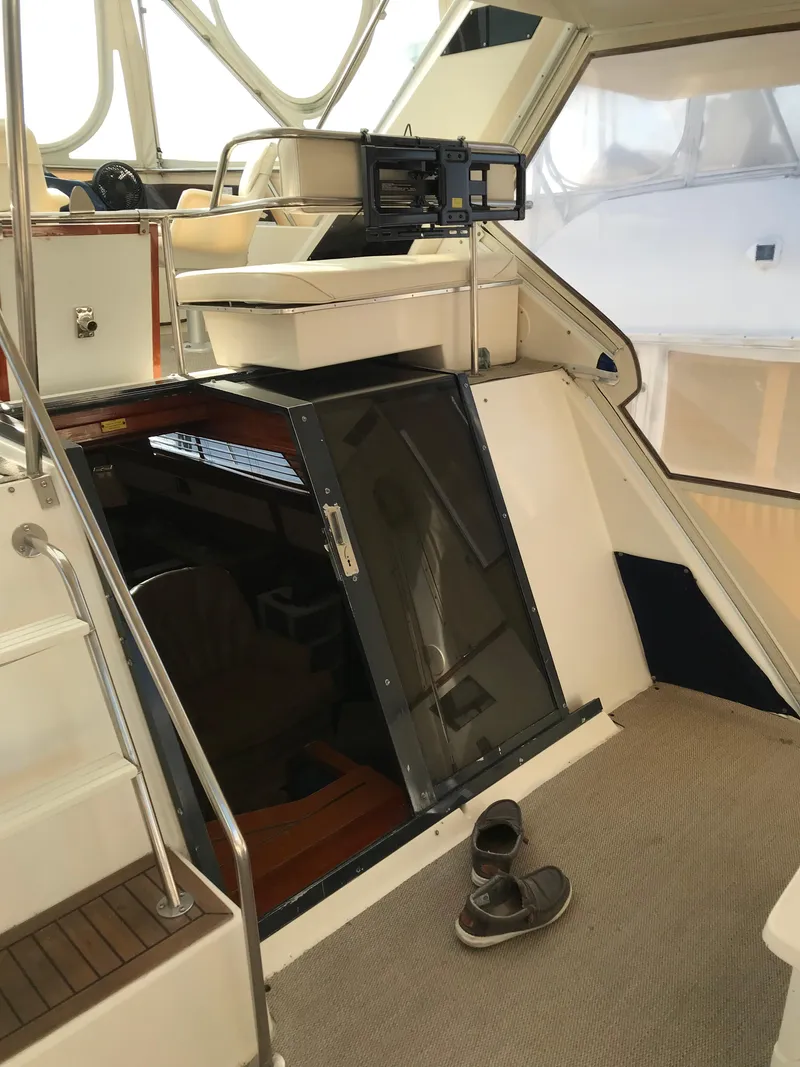 Slide: The Image of 1987 Sea Ray 410 Aft Cabin interior with stairs and open cabin door. - 26