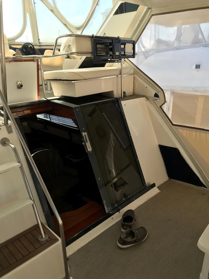 Slide: The Image of 1987 Sea Ray 410 Aft Cabin interior with stairs and open hatch. - 29