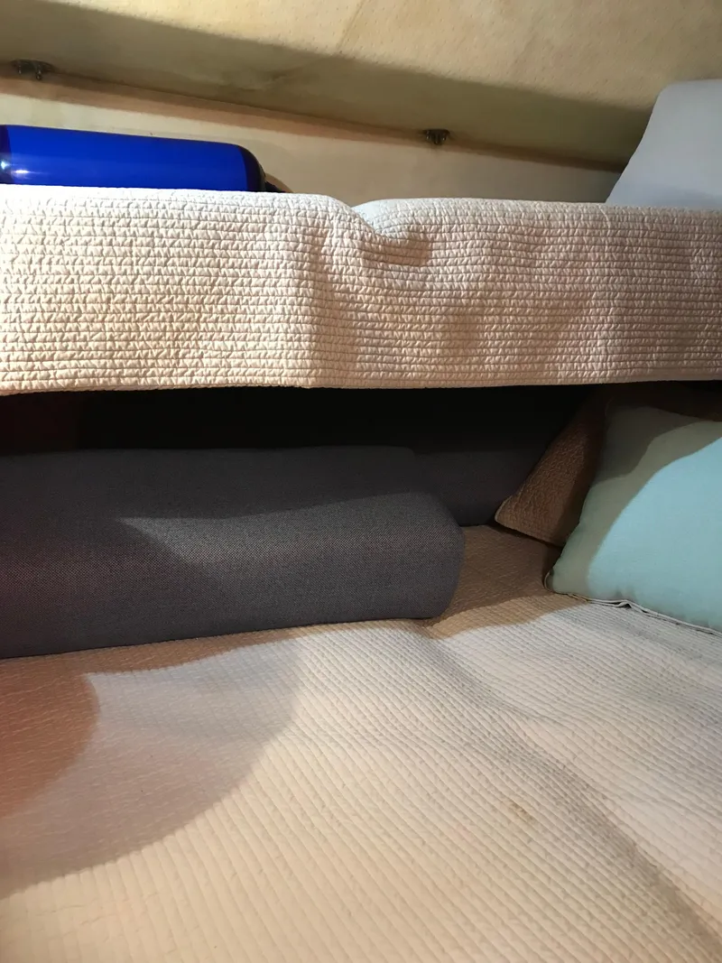 Slide: The Image of Interior cabin view of 1987 Sea Ray 410 Aft Cabin with bedding and cushions. - 32