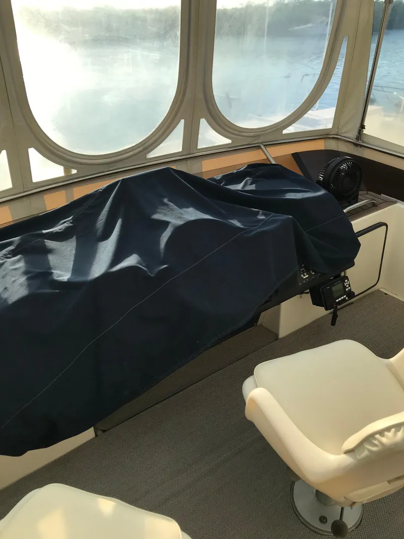 Slide: The Image of 1987 Sea Ray 410 Aft Cabin interior with covered controls and seating. - 38