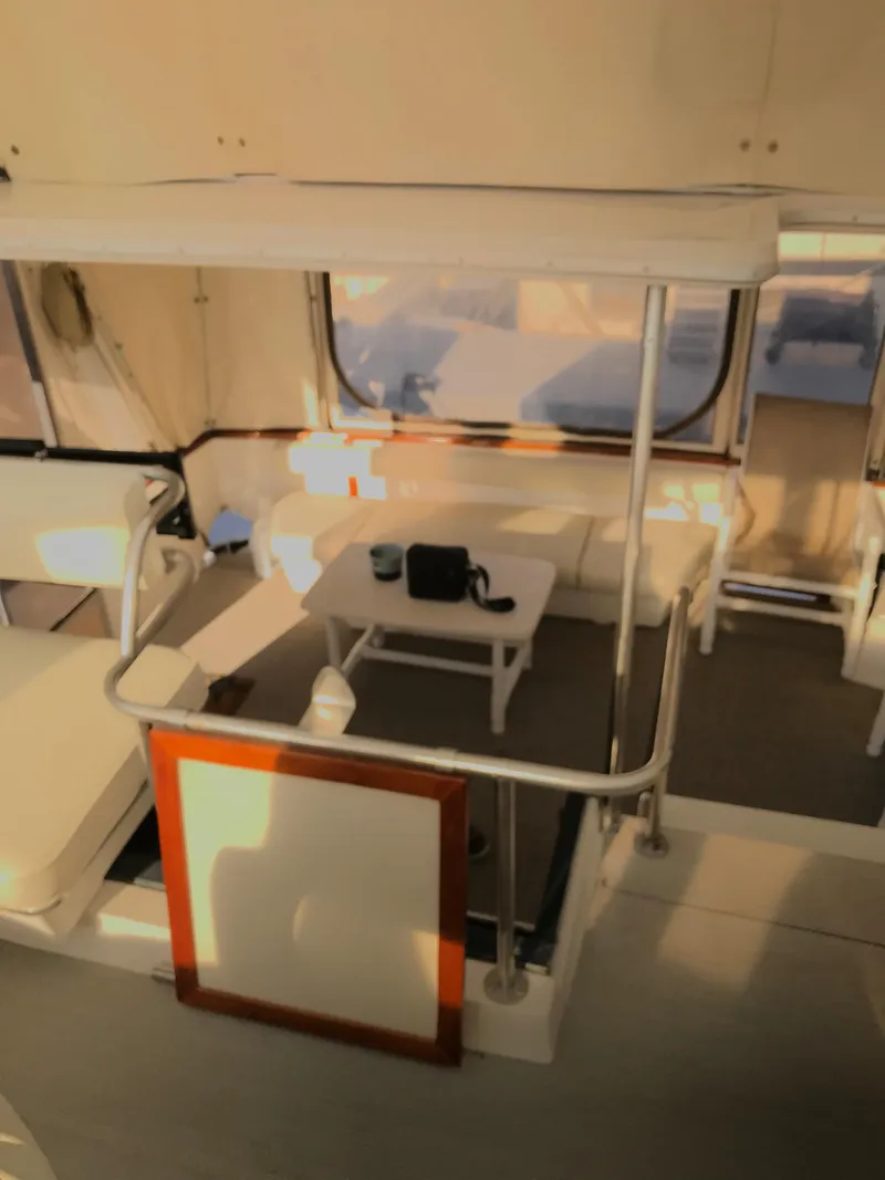 Slide: The Image of 1987 Sea Ray 410 Aft Cabin interior with seating and table, showcasing spacious design. - 50