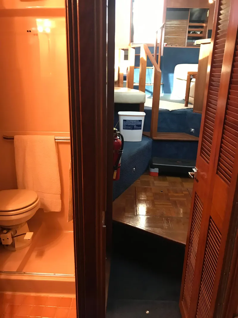 Slide: The Image of 1987 Sea Ray 410 Aft Cabin interior with bathroom and stairs. - 67