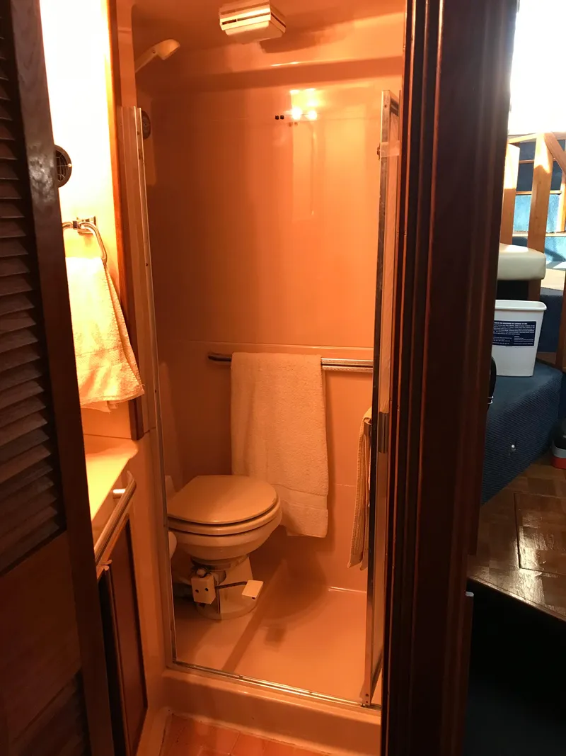Slide: The Image of 1987 Sea Ray 410 Aft Cabin bathroom with shower and toilet. - 68