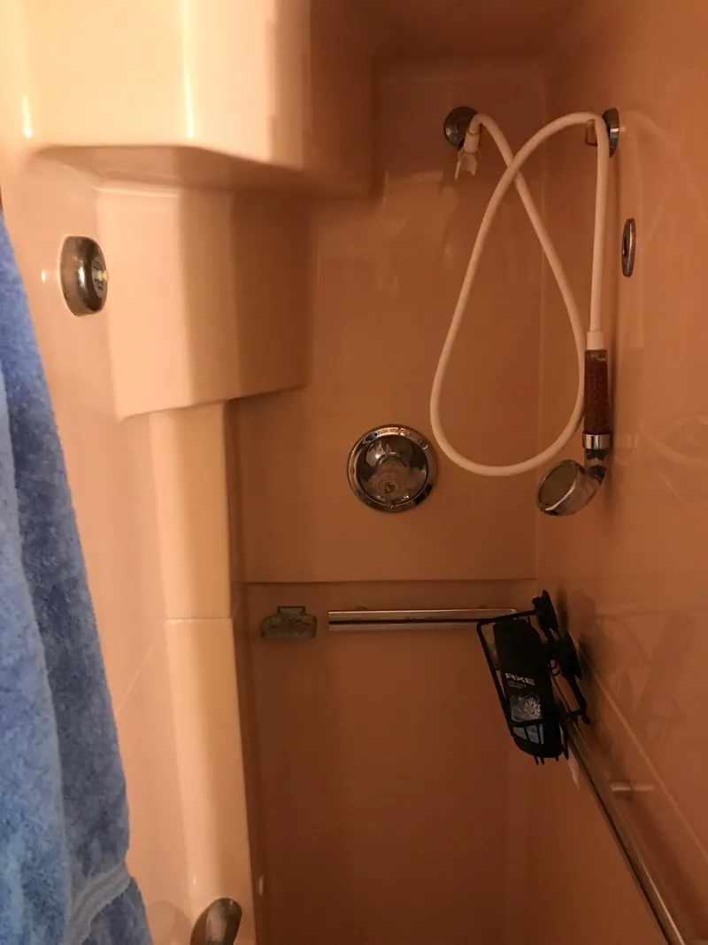 Slide: The Image of Shower area in 1987 Sea Ray 410 Aft Cabin yacht with towel and showerhead. - 79