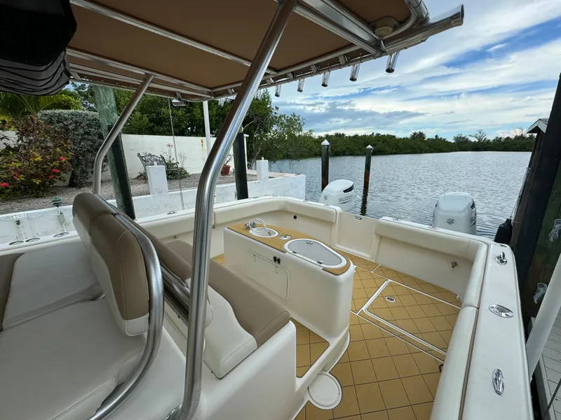 Slide: The Image of Mamba 350 boat interior, 2009 model, docked by a serene waterfront. - 10