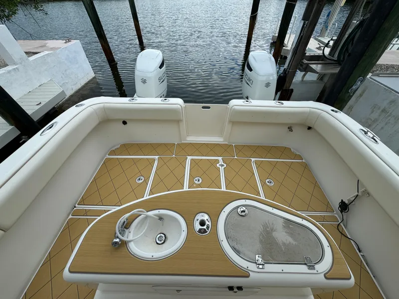 Slide: The Image of Mamba 350 boat deck, 2009 model, with twin outboard motors at dock. - 12