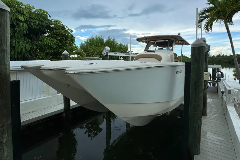 Slide: The Image of 2009 Mamba 350 boat docked near tropical trees and calm water. - 17