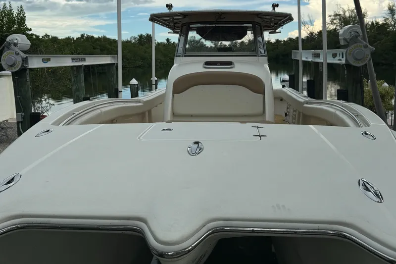 Slide: The Image of 2009 Mamba 350 boat docked, showcasing spacious deck and sleek design. - 18