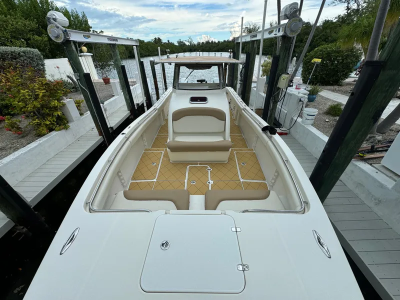 Slide: The Image of Mamba 350 boat, 2009 model, docked with spacious seating and sleek design. - 3
