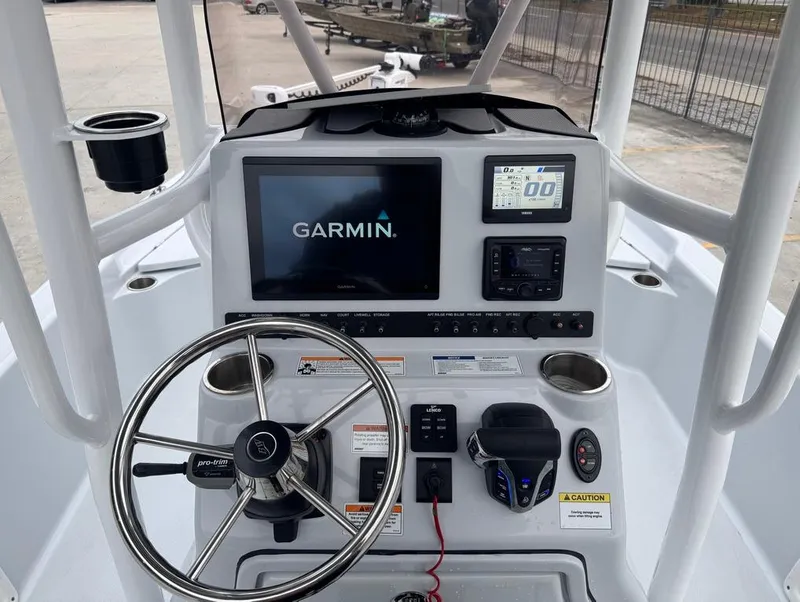 Slide: The Image of 2024 Blue Wave 2400 PureBay boat console with Garmin navigation system and steering wheel. - 12