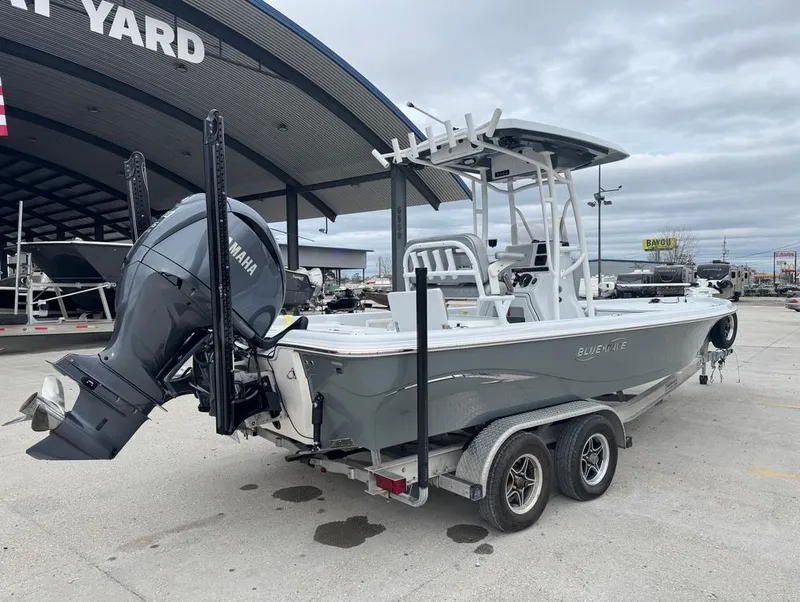 Slide: The Image of 2024 Blue Wave 2400 PureBay boat on trailer, featuring Yamaha outboard motor. - 5