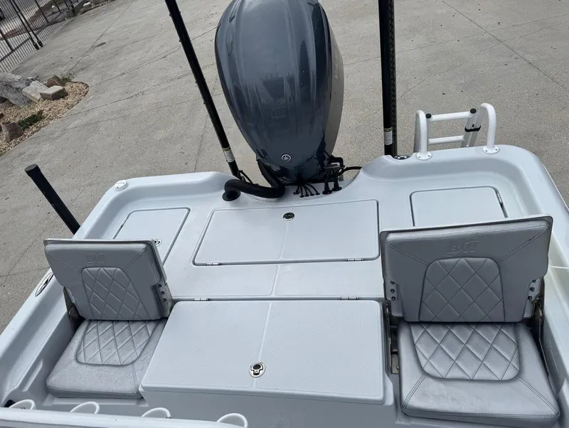 Slide: The Image of 2024 Blue Wave 2400 PureBay boat with dual foldable seats and outboard motor. - 9