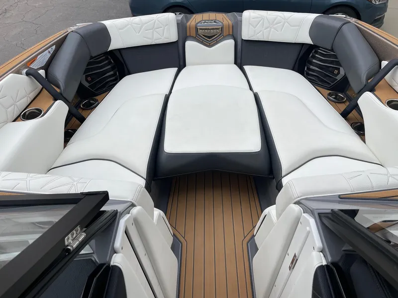 Slide: The Image of 2023 Nautique Super Air Nautique G25 Paragon interior with luxurious seating and wood accents. - 11