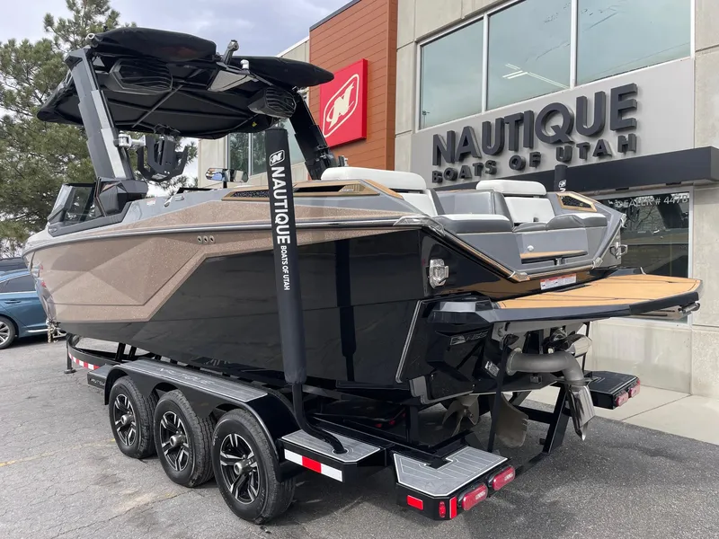 Slide: The Image of 2023 Nautique Super Air Nautique G25 Paragon boat on trailer outside dealership. - 3