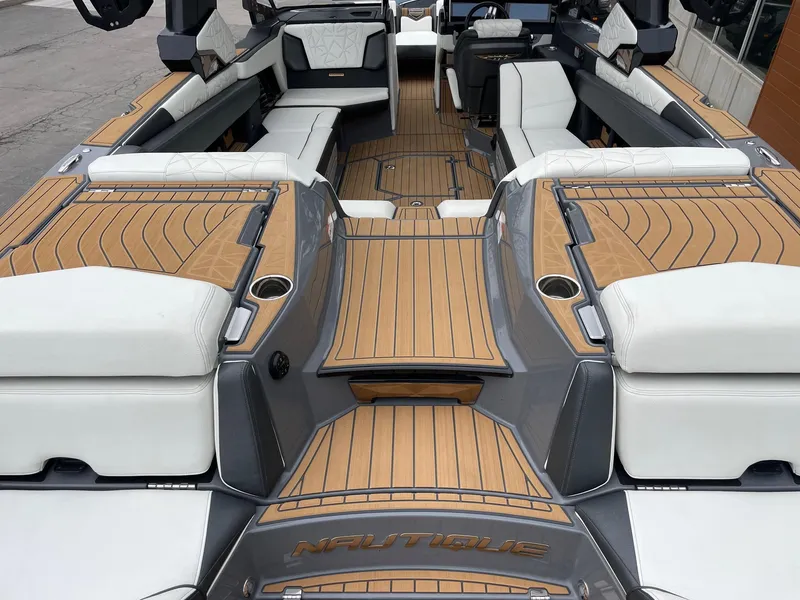 Slide: The Image of 2023 Nautique Super Air Nautique G25 Paragon interior with luxurious seating and teak flooring. - 4