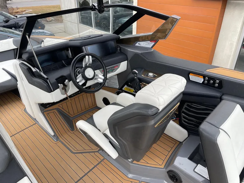 Slide: The Image of 2023 Nautique Super Air Nautique G25 Paragon interior with luxury seating and modern dashboard. - 6