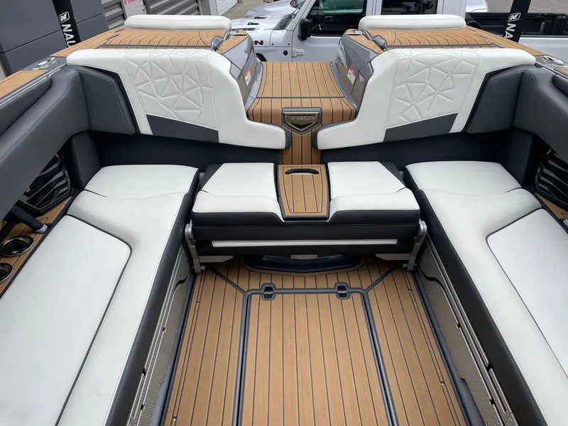 Slide: The Image of 2023 Nautique Super Air Nautique G25 Paragon interior with luxurious seating and teak flooring. - 8