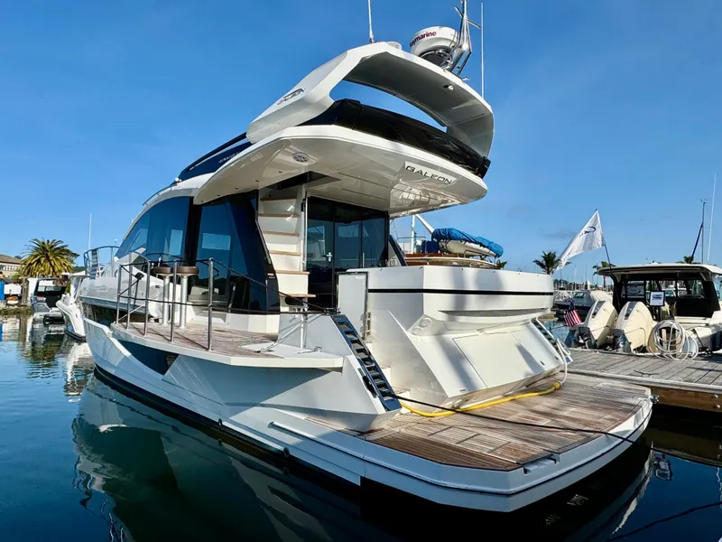 Slide: The Image of 2024 Galeon 470 Sky yacht docked at marina, showcasing sleek design and modern features. - 2