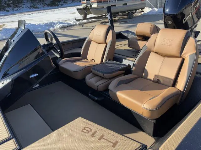 Slide: The Image of 2025 Xpress H18 boat interior with tan leather seats and steering wheel. - 11