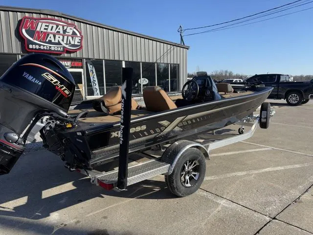 Slide: The Image of 2025 Xpress H18 boat on trailer at Wieda's Marine dealership. - 3