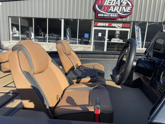 Slide: The Image of 2025 Xpress H18 boat interior with tan seats at Weda's Marine dealership. - 6