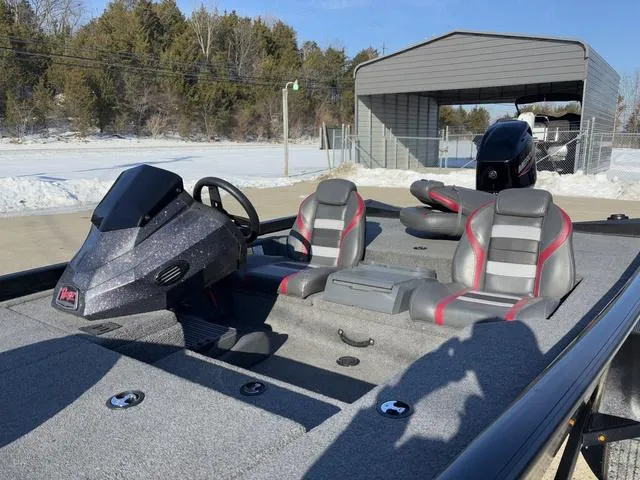 Slide: The Image of 2021 Ranger RT178 boat interior with dual seats and steering console, parked outdoors. - 10