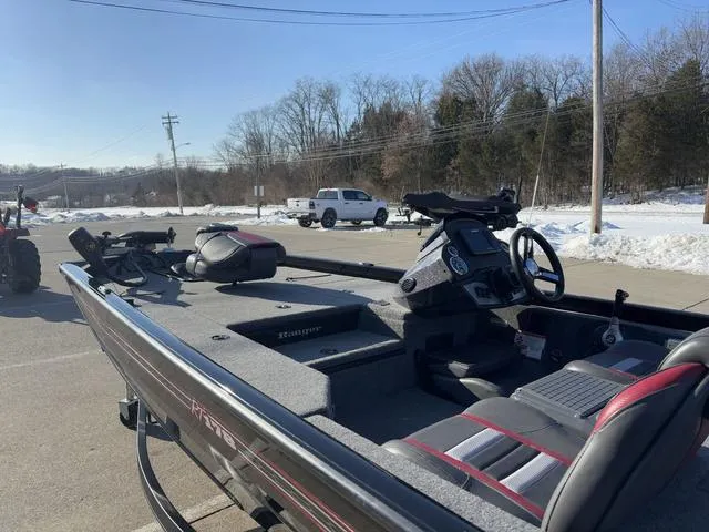 Slide: The Image of 2021 Ranger RT178 boat parked in snowy lot, showcasing interior and controls. - 12