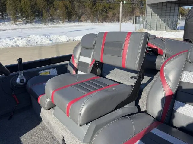 Slide: The Image of 2021 Ranger RT178 boat interior with gray and red seats in snowy outdoor setting. - 13