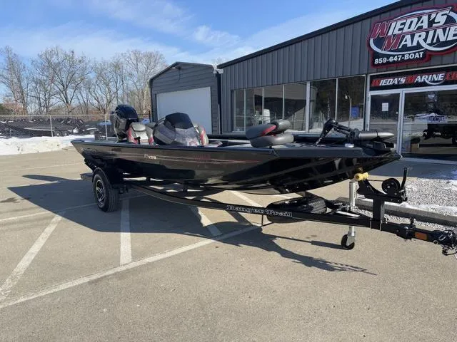 Slide: The Image of 2021 Ranger RT178 boat parked outside a marine dealership on a sunny day. - 7