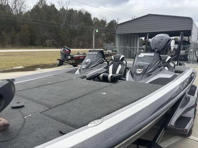 Slide: The Image of 2020 Skeeter FXR20 Limited bass boat with dual seats, parked outdoors. - 12