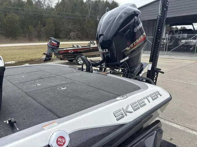 Slide: The Image of 2020 Skeeter FXR20 Limited boat with Yamaha engine, parked outdoors. - 15
