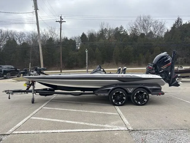 Slide: The Image of 2020 Skeeter FXR20 Limited boat on trailer in parking lot, overcast sky. - 17