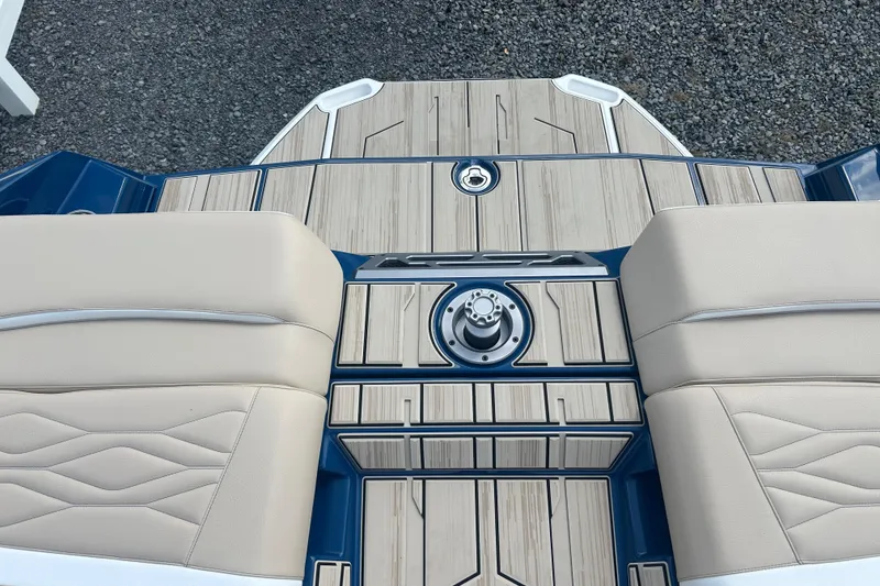 Slide: The Image of 2025 Supra SV boat interior with beige seating and sleek wood paneling. - 12