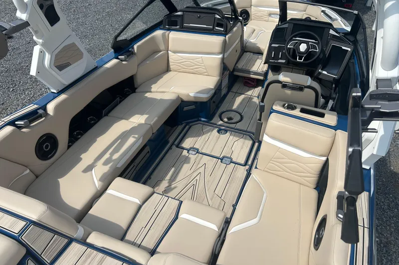 Slide: The Image of 2025 Supra SV boat interior with beige seating and modern dashboard design. - 21