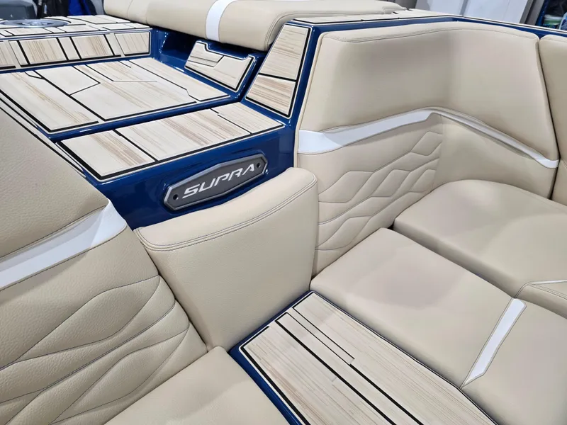 Slide: The Image of 2025 Supra SV interior with beige leather seats and wood accents. - 24