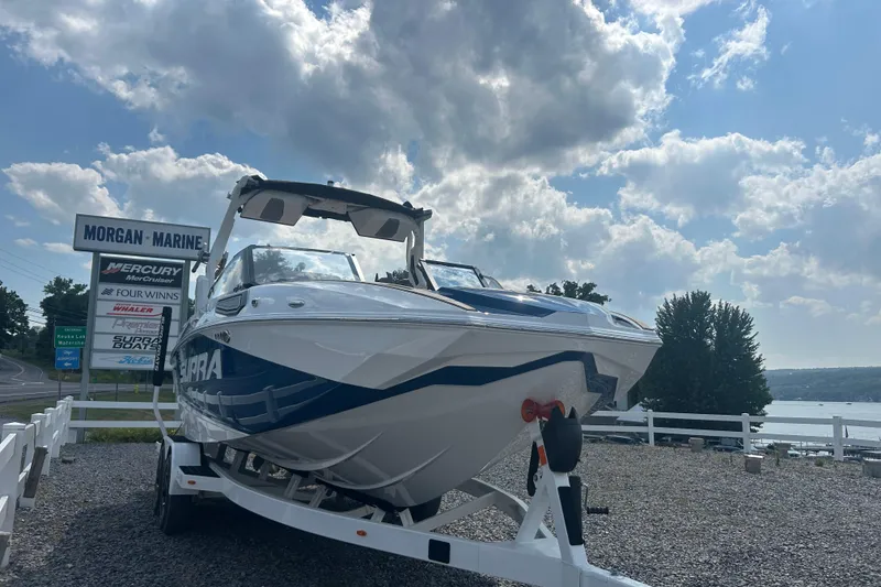 Slide: The Image of 2025 Supra SV boat on trailer at Morgan Marine, under a partly cloudy sky. - 3