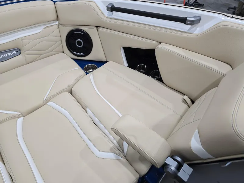 Slide: The Image of 2025 Supra SV boat interior with beige leather seats and built-in speaker. - 32