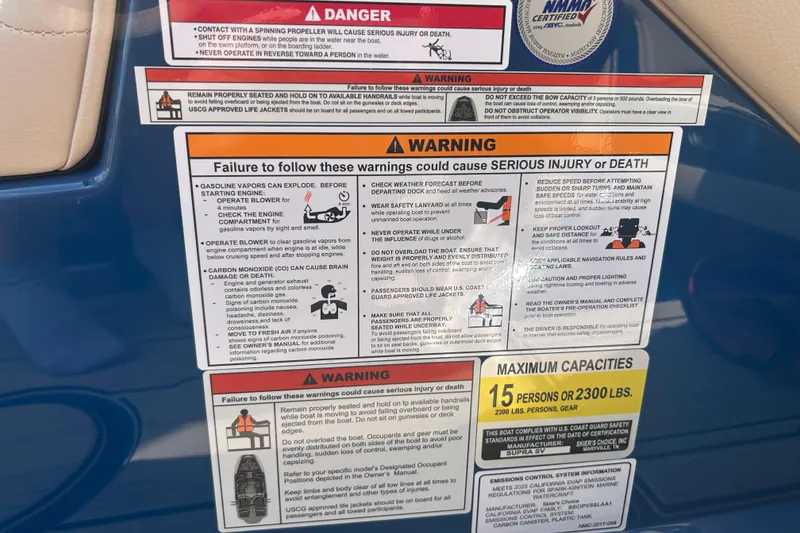 Slide: The Image of Warning labels and capacity information on a 2025 Supra SV boat. - 34