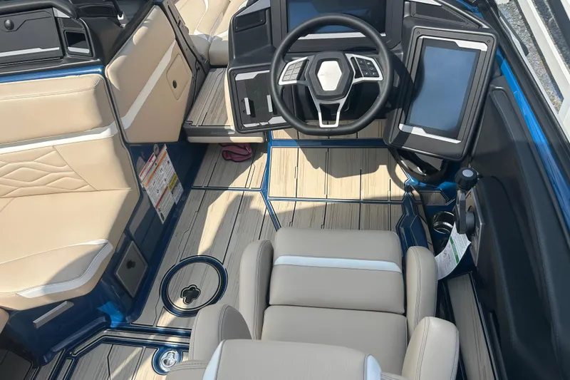 Slide: The Image of 2025 Supra SV boat interior with modern dashboard, touchscreen, and beige seating. - 35