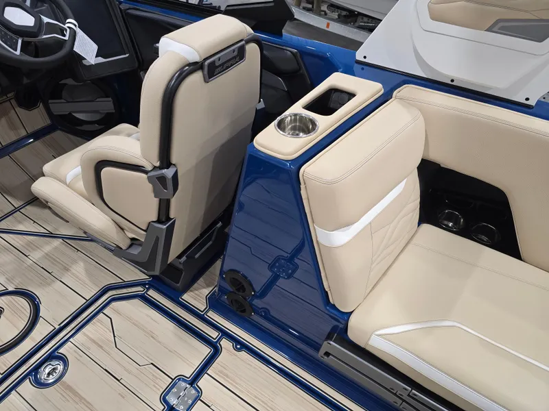 Slide: The Image of 2025 Supra SV interior with beige seats and blue accents, featuring a cup holder. - 38
